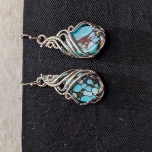 Silvery and teal earrings.